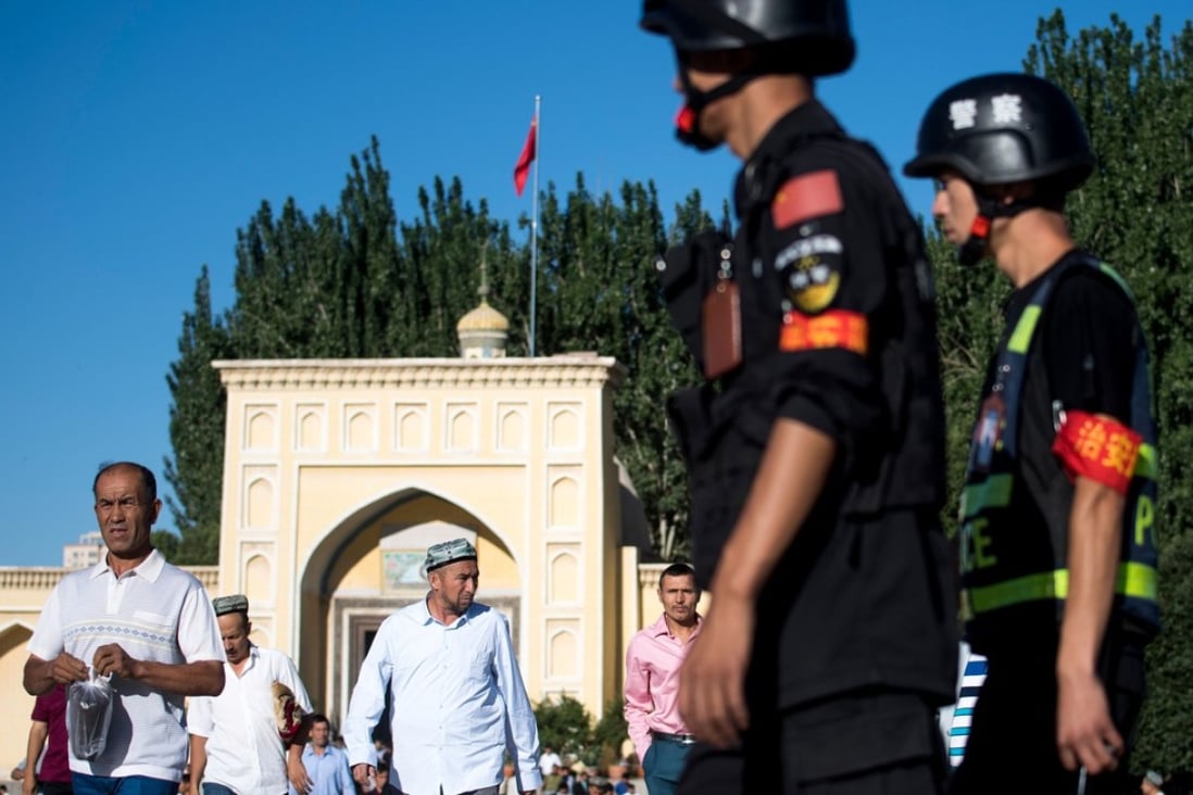 Police patrol as Muslims leave Kashgar’s Id Kah Mosque after morning prayer on Eid al-Fitr in China's Xinjiang Uighur autonomous region. Photo: AFP