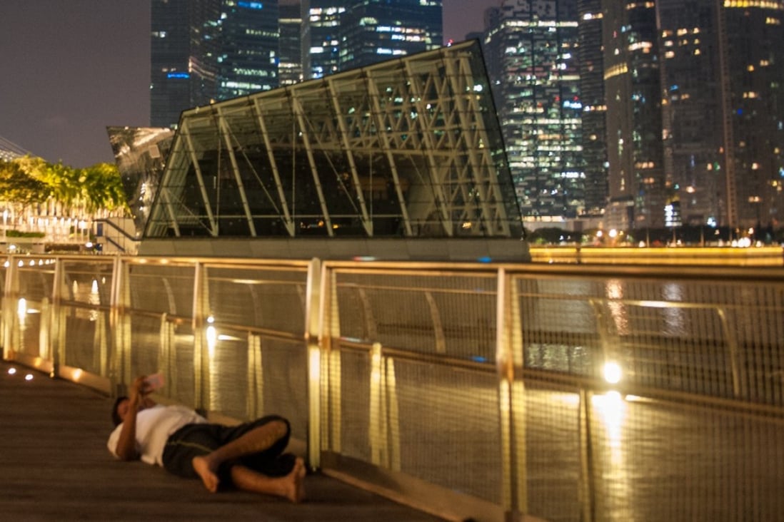 A migrant worker rests on the promenade near Singapore’s Marina Bay Sands casino. A number of migrant workers have gambled their way into debt. Photo: Justin Kor