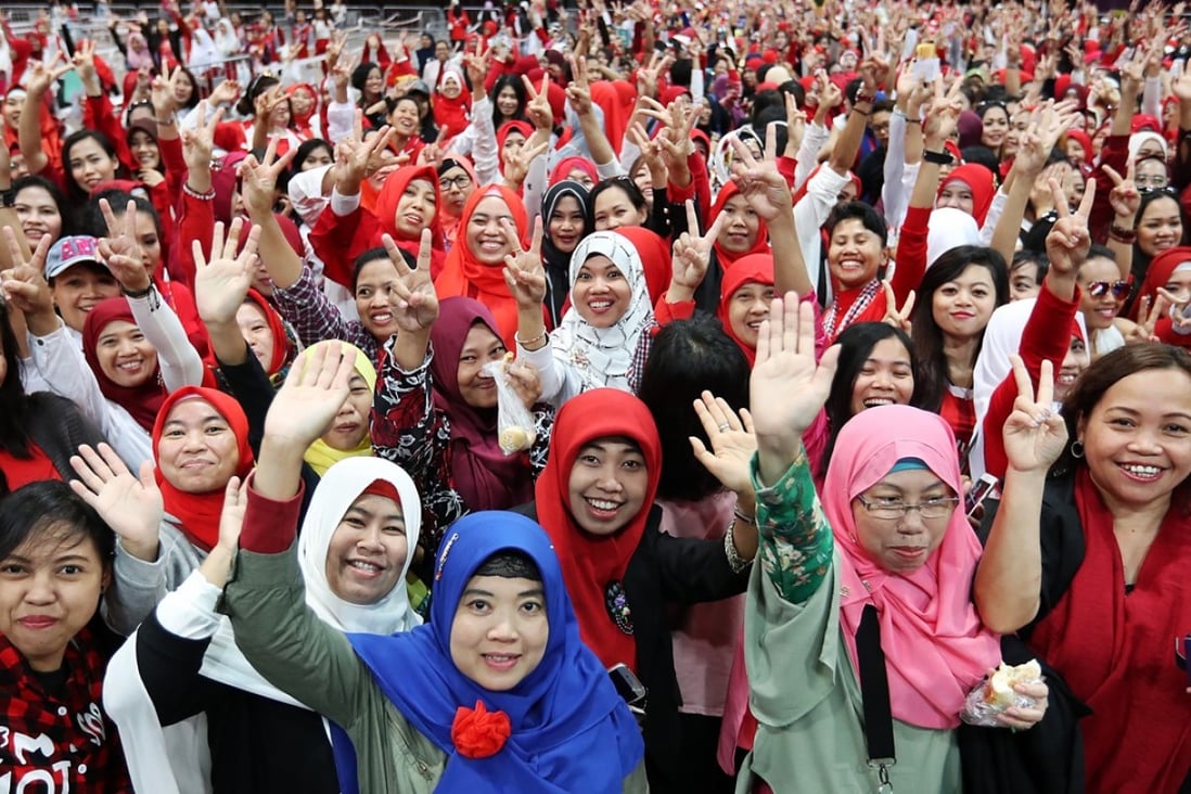 Indonesian domestic helpers attend an event in Chek Lap Kok. Photo: Edward Wong