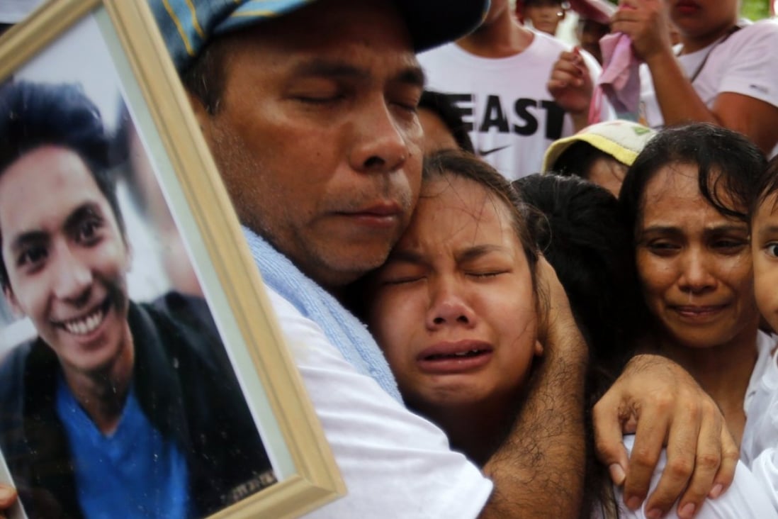 The family of Ephraim Escudero, a victim of extrajudicial killing in the Philippines, mourn during his burial at a cemetery in San Pedro city on September 30. President Rodrigo Duterte's war on drugs has killed more than 7,000 people since his election last summer, with polling showing most of the public believe the police have carried out extrajudicial killings. Photo: EPA-EFE