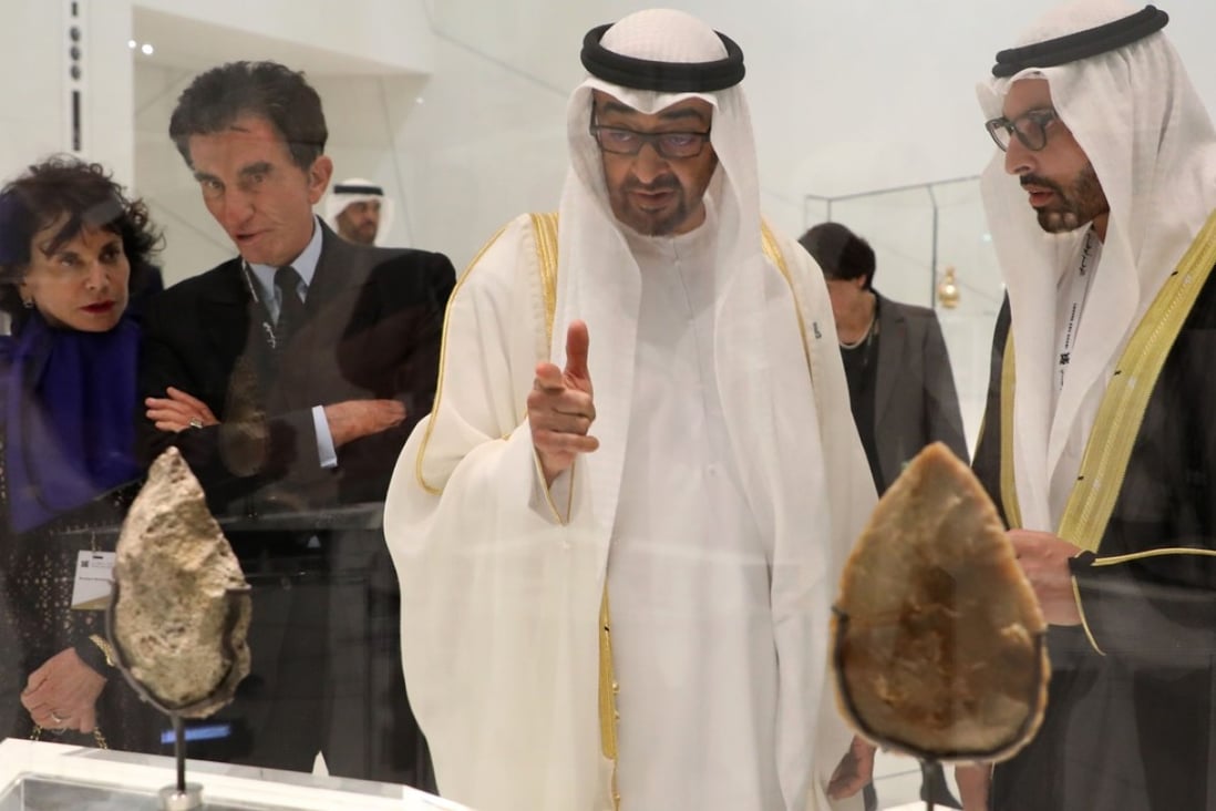 Abu Dhabi Crown Prince Mohammed bin Zayed Al-Nahyan (2L) and the chairman of Abu Dhabi's Tourism and Culture Authority, Mohamad Khalifa al-Mubarak look at a piece of art as they visit the Louvre Abu Dhabi Museum on November 8, 2017 during its inauguration on Saadiyat island in the Emirati capital. Photo: Agence France-Presse