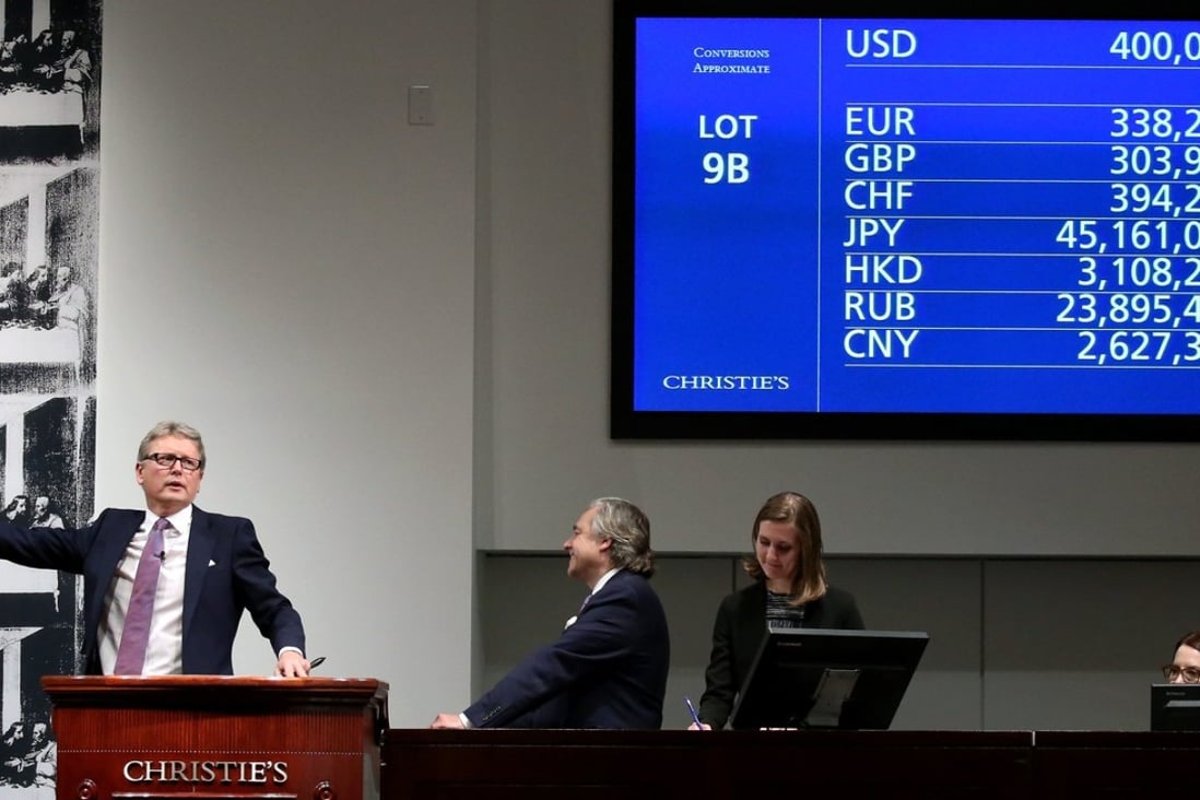 Christie’s global president Jussi Pylkkanen takes the winning hammer bid of US$400 million on “Salvator Mundi” by Leonardo da Vinci at auction in New York. The buyer will pay a total of US$450.3 million for the painting. Photo: EPA