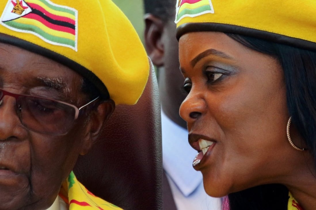 Zimbabwean first lady Grace Mugabe speaks into her husband President Robert Mugabe’s ear during a ruling party rally. Photo: Reuters
