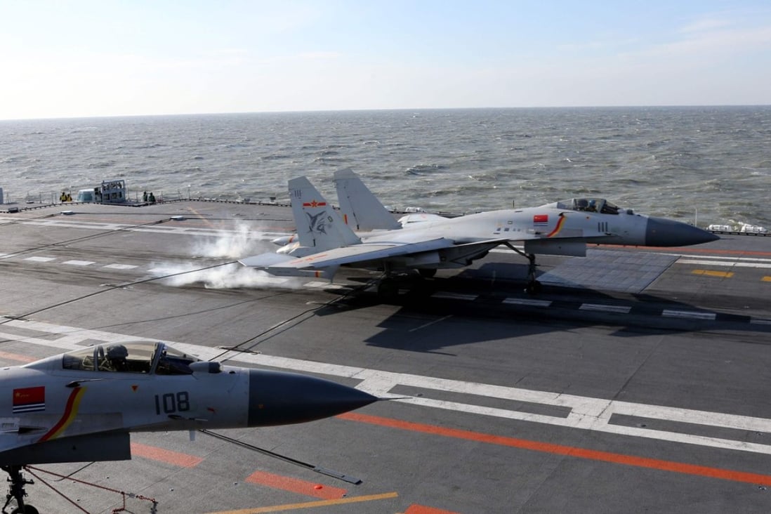 A J-15 fighter jet lands on the deck of the PLA Navy aircraft carrier Liaoning during military drills in the Bohai Sea, off China's northeast coast, in December last year. Photo: AFP