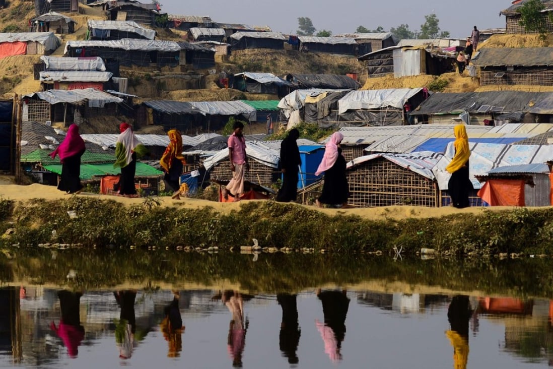 Rohingya refugees walk back to their homes at the Balukhali refugee camp in Bangladesh. Several sessions at the Dhaka Lit Fest focused on their plight. Photo: AFP
