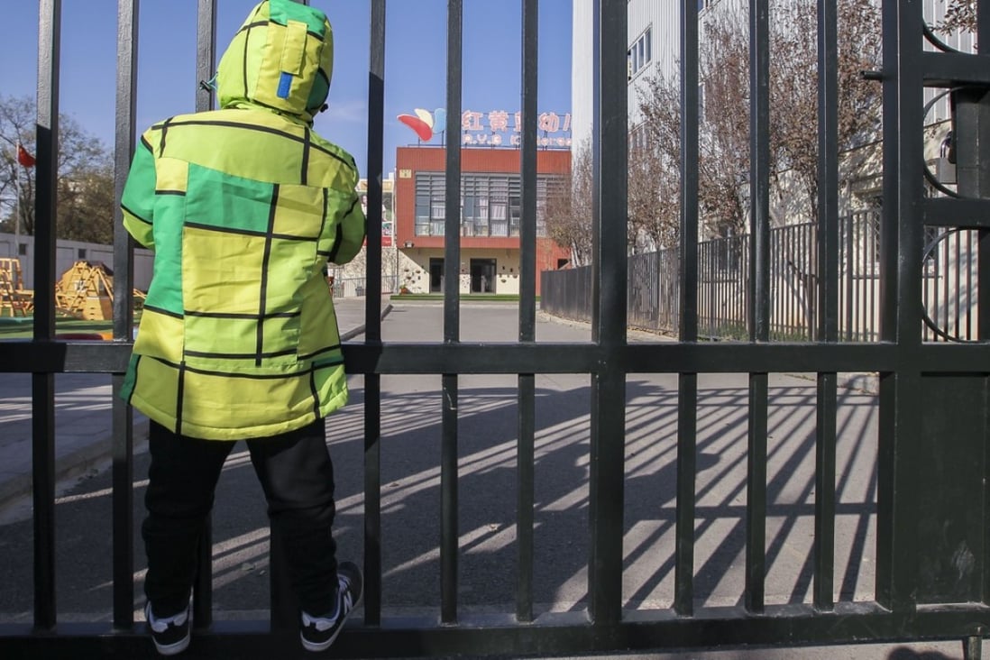 A boy looks through the gates of the RYB Education New World kindergarten in Beijing on Friday. Photo: Simon Song