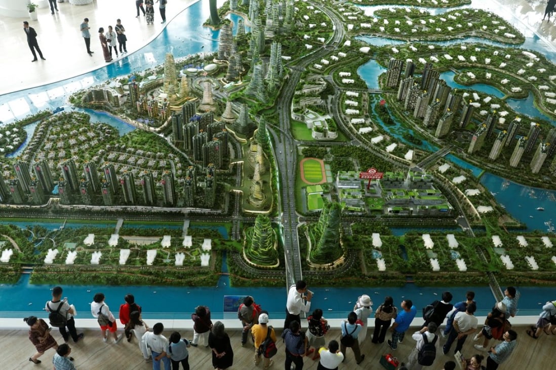 Prospective buyers look at a model of the development at the Country Gardens' Forest City showroom in Johor Baharu, Malaysia in February. Photo: Reuters