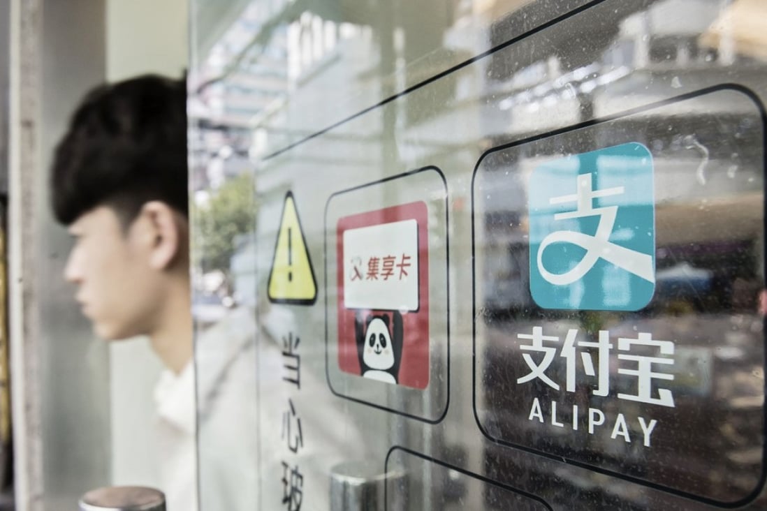 Signage for Ant Financial Services Group's Alipay payment system, an affiliate of Alibaba Group Holding Ltd., is displayed on a store entrance in Shanghai, China, on Wednesday, Aug. 31, 2016. About 200 million consumers use Alipay at physical stores because of the ease and speed at which consumers can make purchases. Photo: Bloomberg