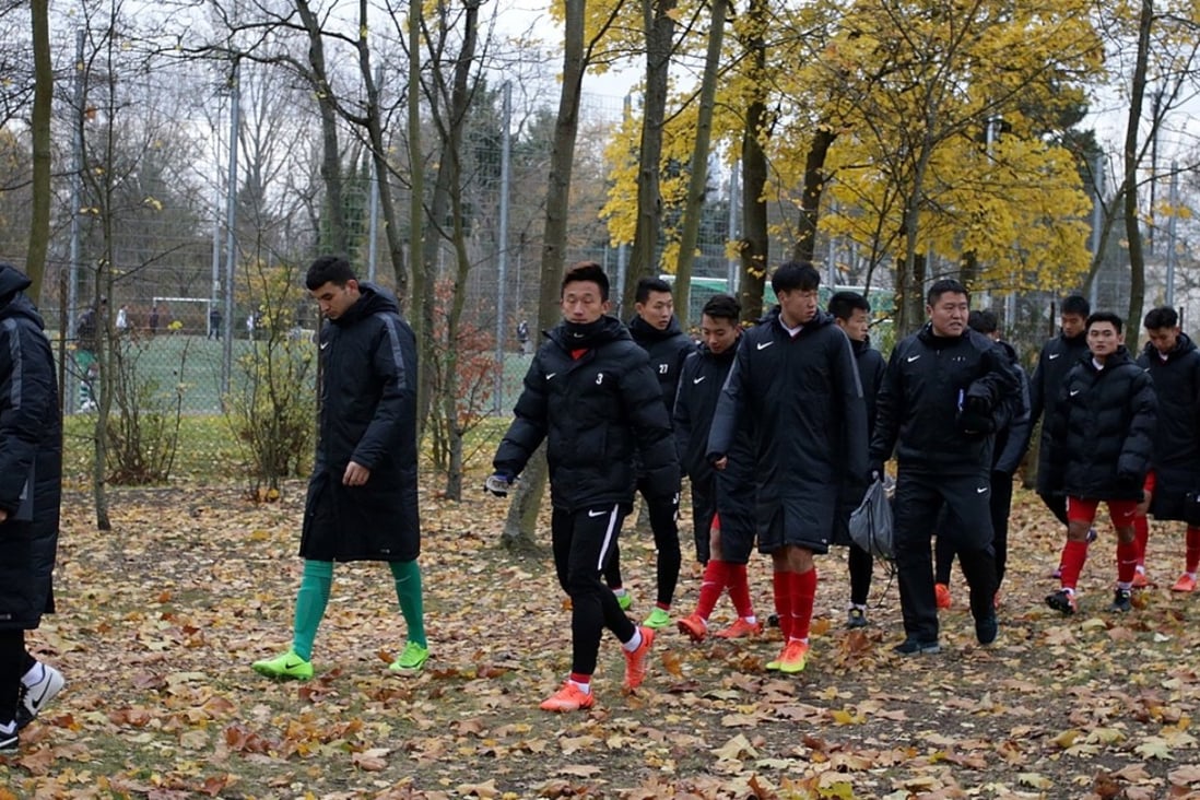 China’s under-20 squad traipses away from a friendly match after demonstrators staged a protest with Tibetan flags in Mainz, Germany. Photo: AP