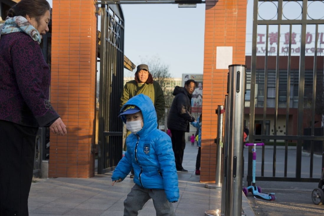 A child arrives to attend the RYB kindergarten in Beijing, China.
