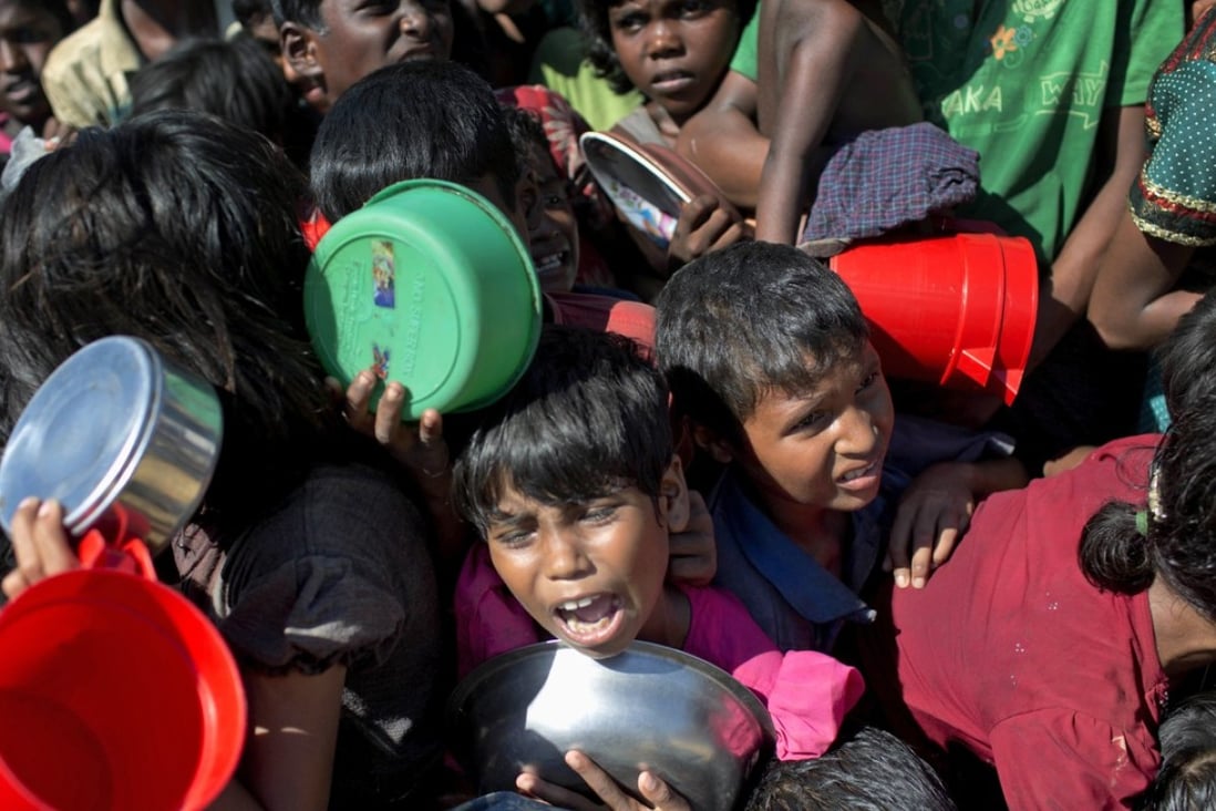 A Rohingya Muslim cries out in the crush of women and children waiting to receive food handouts from a Turkish aid agency at Thaingkhali refugee camp in Ukhiya, Bangladesh, on November 14. Photo: AP