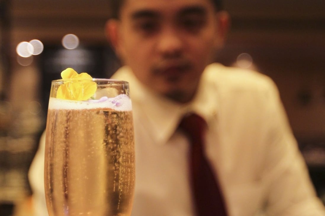 John Paolo Escolano, the bar supervisor at Terroir Parisien, in Central, with a kir royale cocktail. Picture: Roy Issa