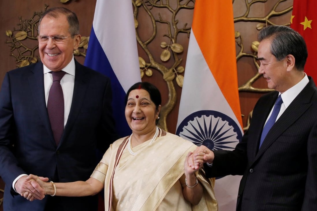 Indian Foreign Minister Sushma Swaraj (centre) smiles as she joins hands with Chinese Foreign Minister Wang Yi (right) and Russian Foreign Minister Sergey Lavrov ahead of their trilateral meeting in New Delhi on Monday. Photo: Reuters