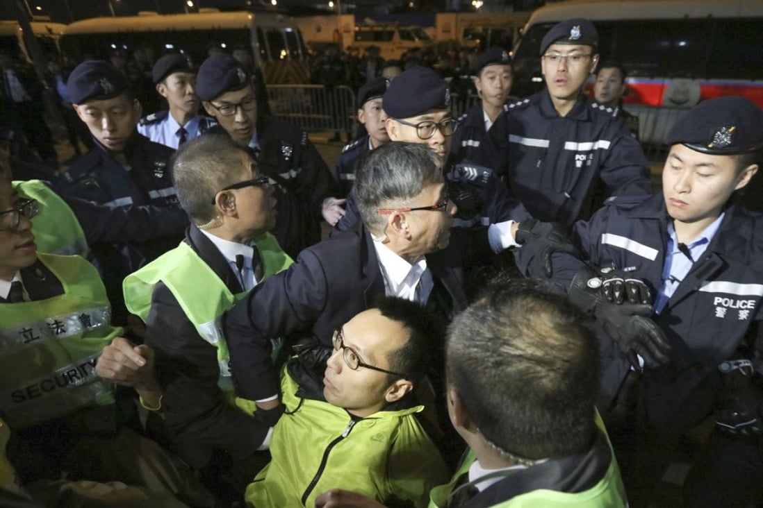 Legislative Council security staff and Hong Kong police began removing protesters from the demonstration zone late Monday evening. Photo: Felix Wong
