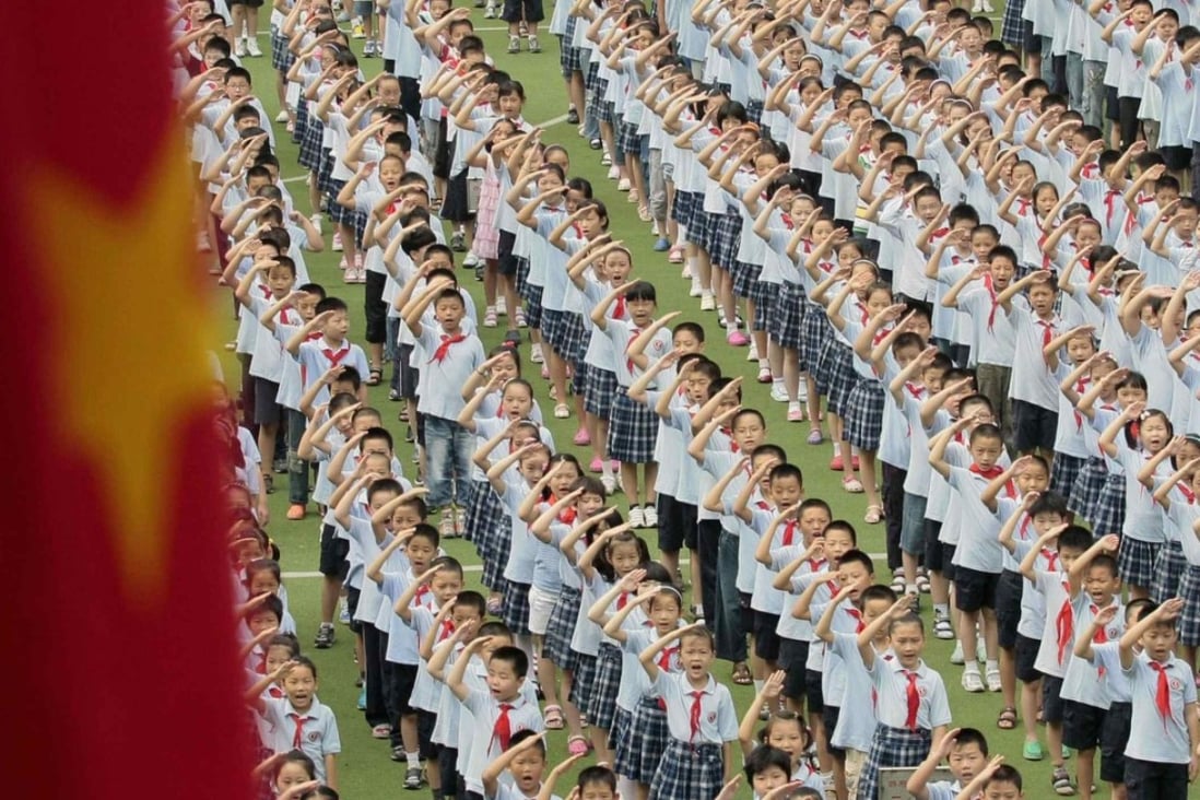 Chinese pupils salute during a flag raising ceremony at a primary school in Nanjing, Jiangsu province. Learning through play and experience rather than by rote in early education has increasingly found converts in China. Photo: Reuters