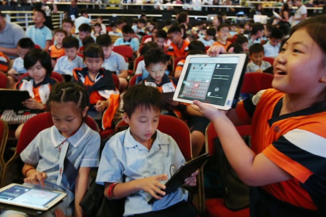 Students attend the “1K VS AI” event at Queen Elizabeth Stadium in Wan Chai, in which 1,000 students played Chinese chess against artificial intelligence systems. Hong Kong needs to prepare students for AI, including training to do things computers cannot do. Photo: David Wong