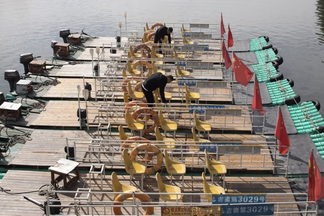 Boatmen prepare rafts for tourists who want to get a closer look at the neighbouring country along the Yalu river between North Korea on the left and China on the right. Photo: AP