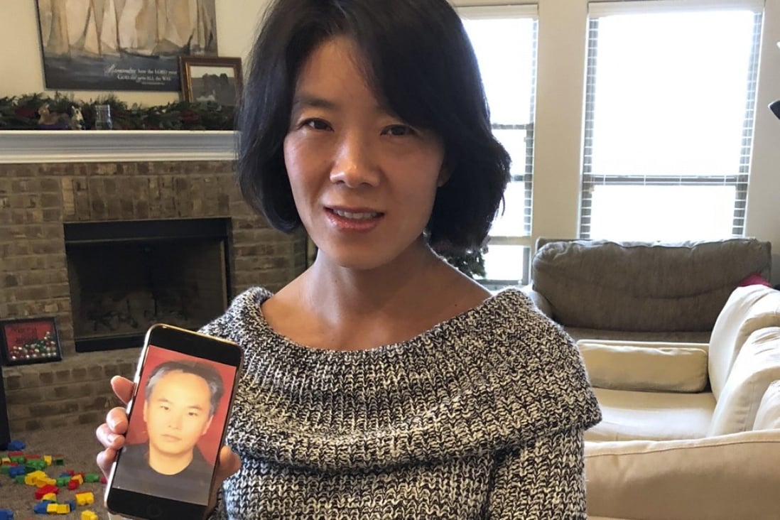 Zhang Haitao’s wife Li Aijie shows a picture of her husband. Li is now seeking political asylum in the United States. Photo: AP