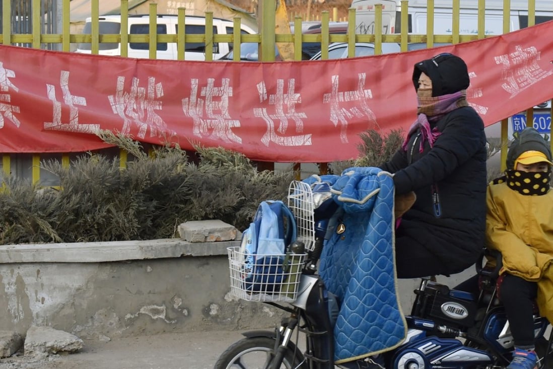 A banner in a Beijing suburb this month reads ‘Don't bring coal to the village’. Photo: Kyodo
