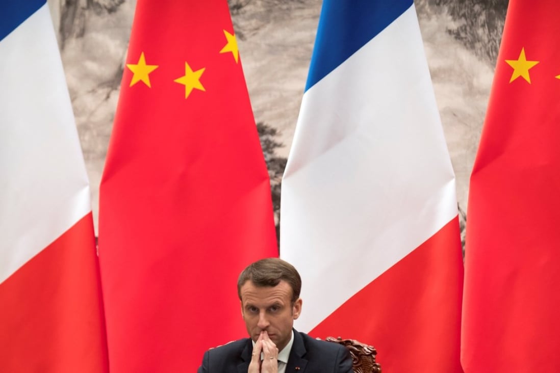 French President Emmanuel Macron watches a signing ceremony between French and Chinese firms at the Great Hall of the People, in Beijing, on Wednesday. Photo: Reuters