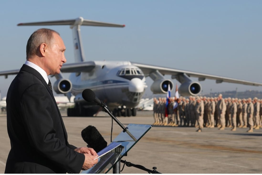 Russian President Vladimir Putin (left) visits the Khmeimim Air Base in Syria on December 11. Photo: EPA