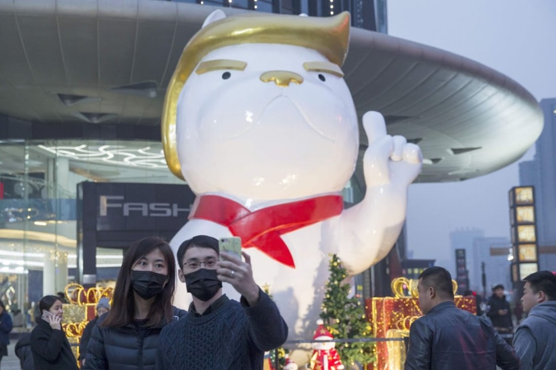 A statue with a likeness to US President Donald Trump heralds the Year of the Dog outside a shopping centre in northern China. There are signs the Trump administration will take some sort of tough trade action against China. Photo: AFP