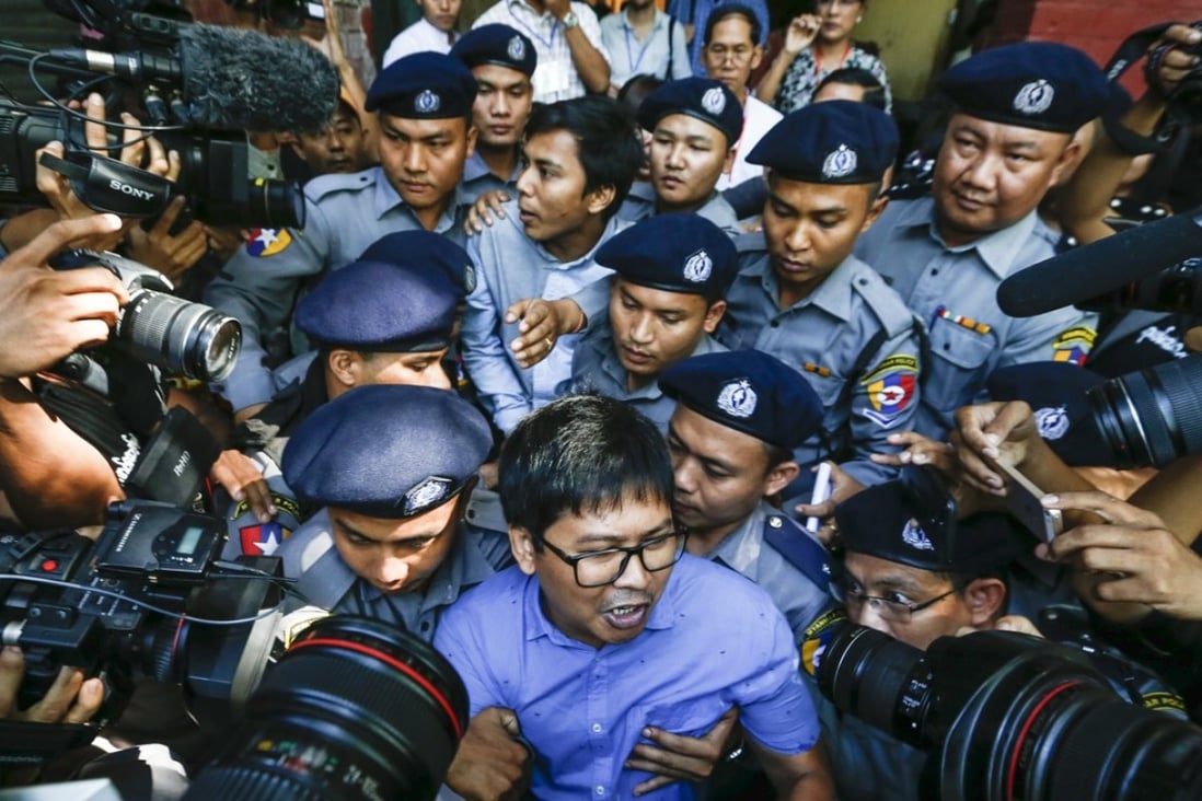 Reuters journalists Wa Lon, centre front, and Kyaw Soe Oo, centre back, are escorted by police as they leave the court in Yangon, Myanmar. Photo: EPA