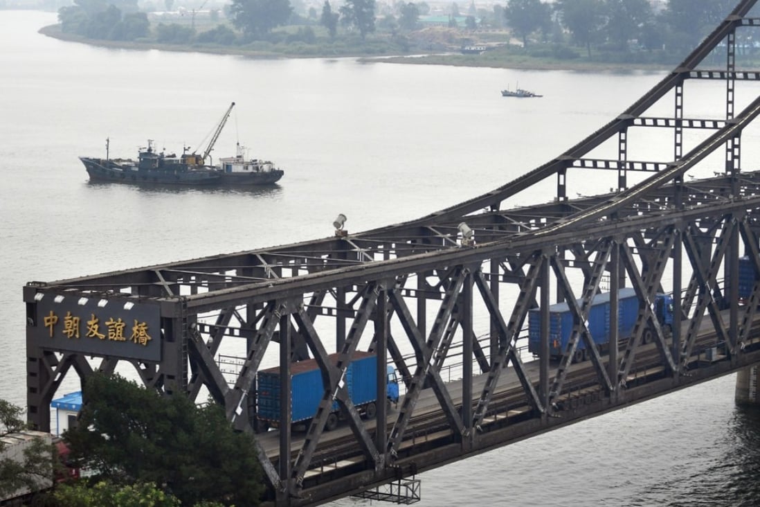Trucks are seen driving across the Sino-Korean Friendship Bridge from China’s Dandong towards North Korea's Sinuiju in this photo taken in September 2017. China reported its imports from North Korea plunged 81.6 per cent in December. Photo: Kyodo