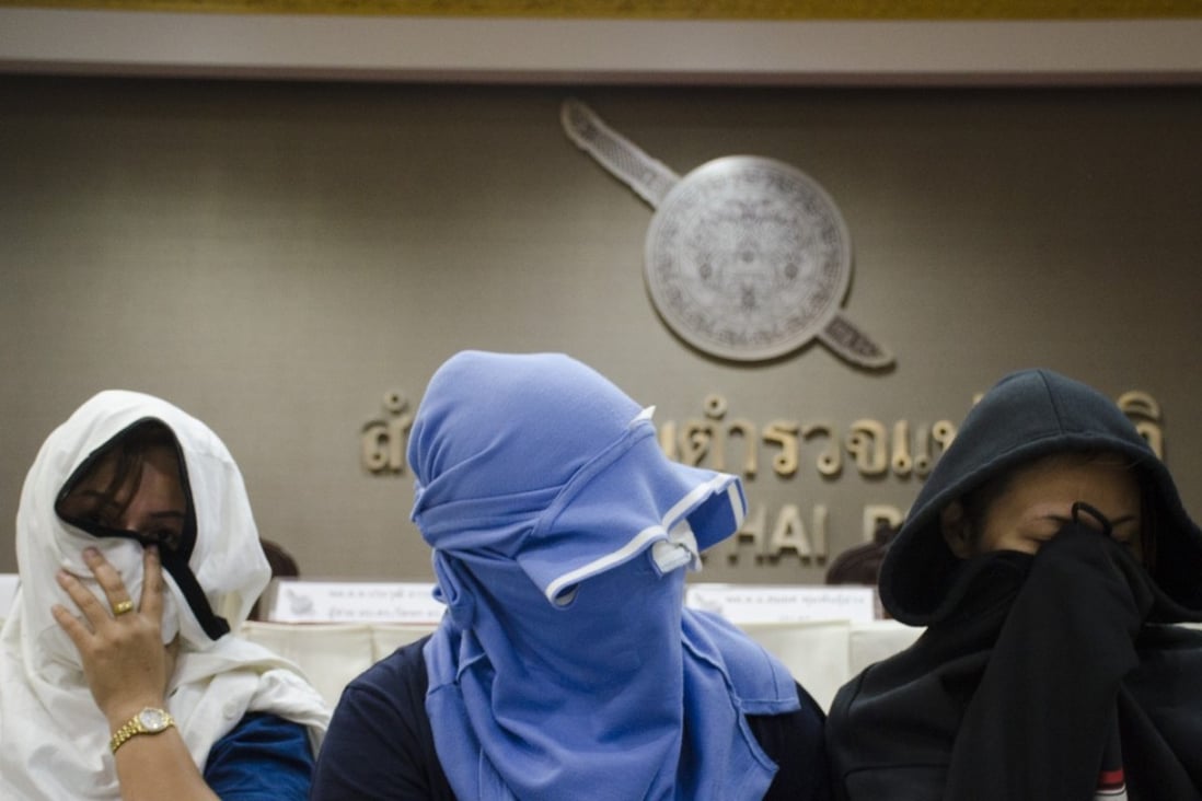 In an August 2015 photo, unidentified Thai suspects are seated at police headquarters in Bangkok. Police said five human traffickers recruited Thai women through social media platforms claiming to be part of a modelling agency, but instead sent these women to China, Malaysia and Singapore. Malaysia plans to set up a special court to tackle human-trafficking cases. Photo: AP