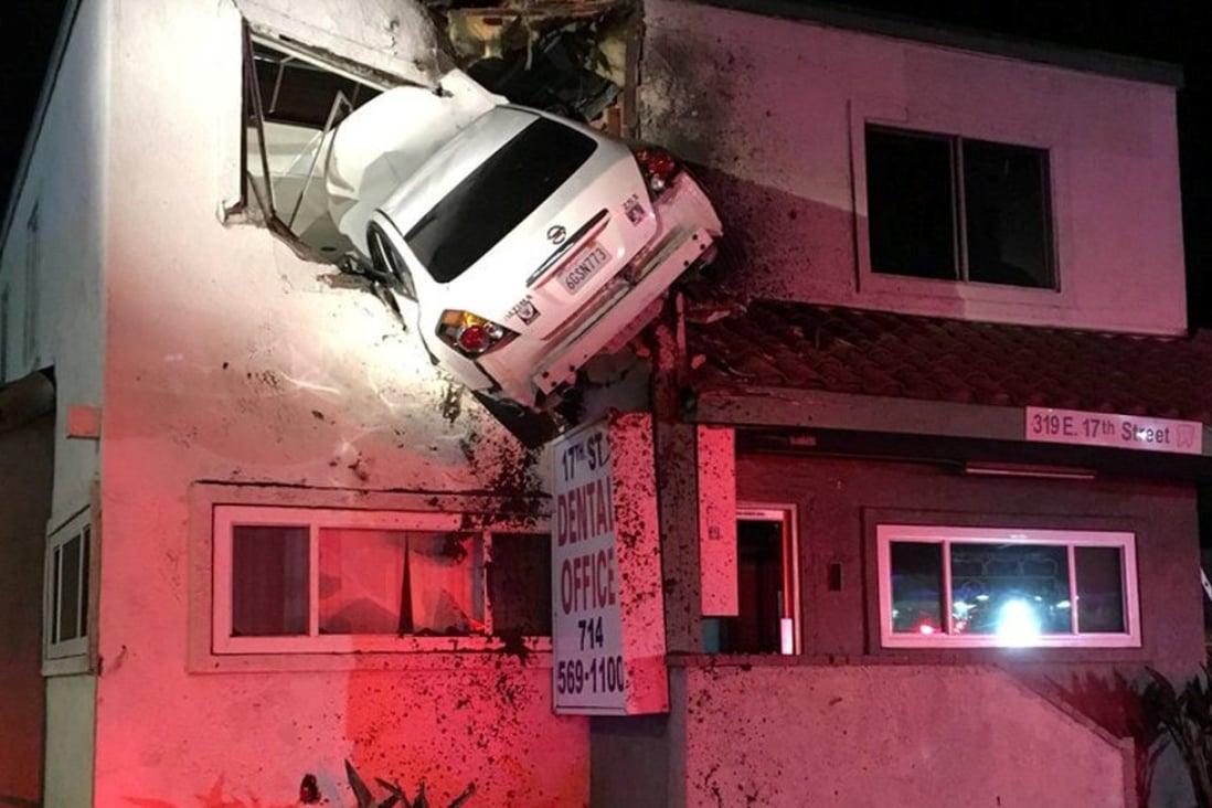 Yes, that’s a car stuck in the second storey of a California building