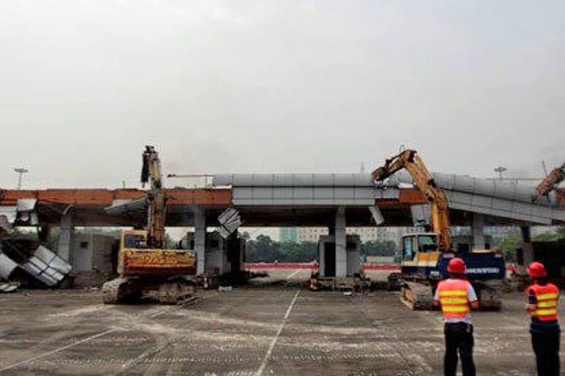 Heavy machinery pull apart the Tongle checkpoint to the Shenzhen Special Economic Zone. Photo: Handout