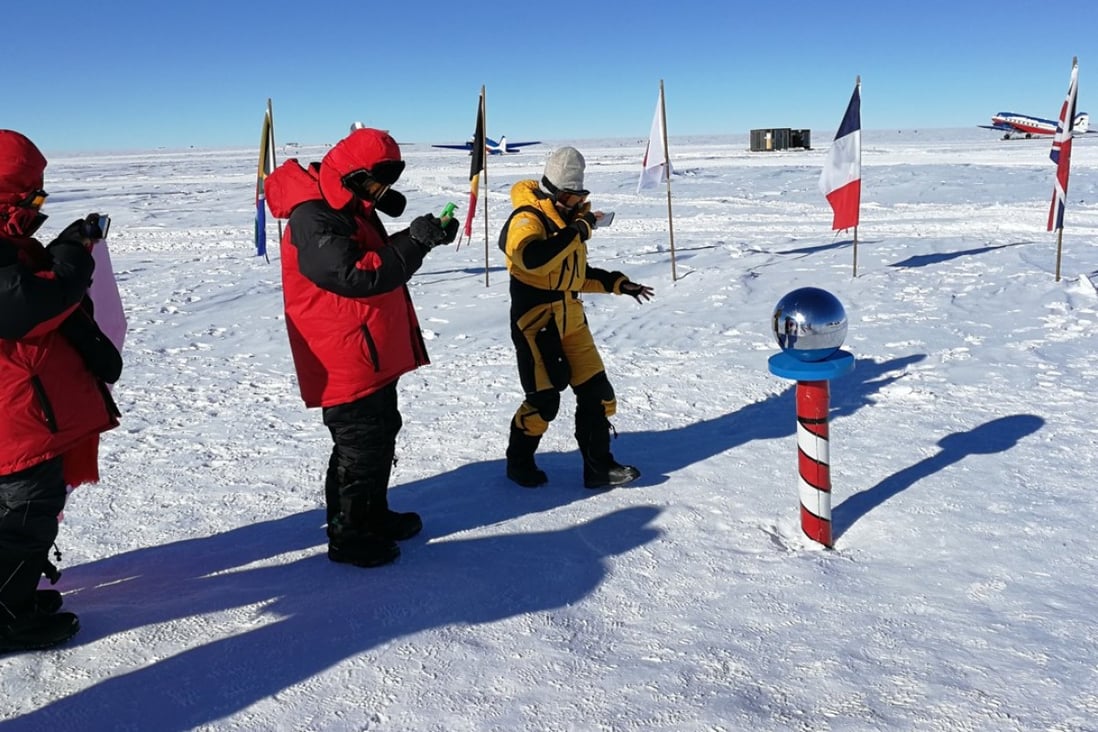 Chinese tourists take photographs of the metal sphere at the South Pole. Photo: Pavel Toropov