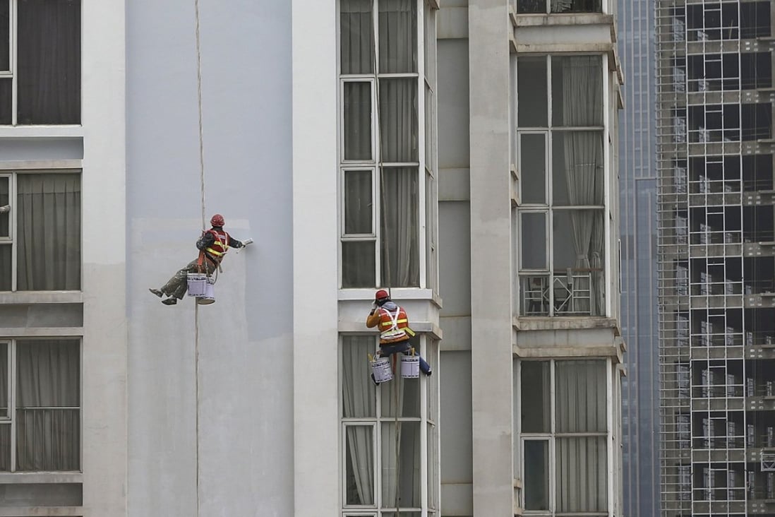 Workers paint the facade of a residential building in Kunming, where property prices rose 2.6 per cent in December from a month earlier. Photo: Reuters