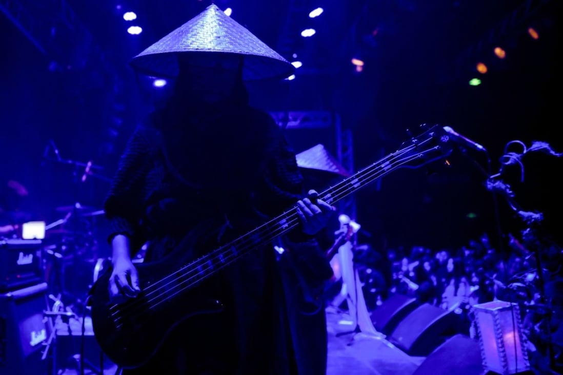 Chinese black metal band Zuriaake, or Lake of Buried Corpses, perform in Beijing. Band members use pseudonyms and never speak at their concerts. Photo: AFP