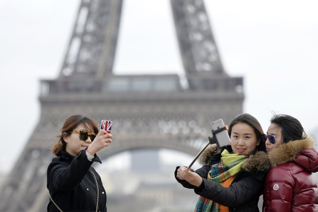 Chinese tourists taking selfie's in front of the Eiffel Tower in Paris. Chinese citizens made a record number of domestic and overseas trips, taking the world’s top spot in 2017. Photo: AFP