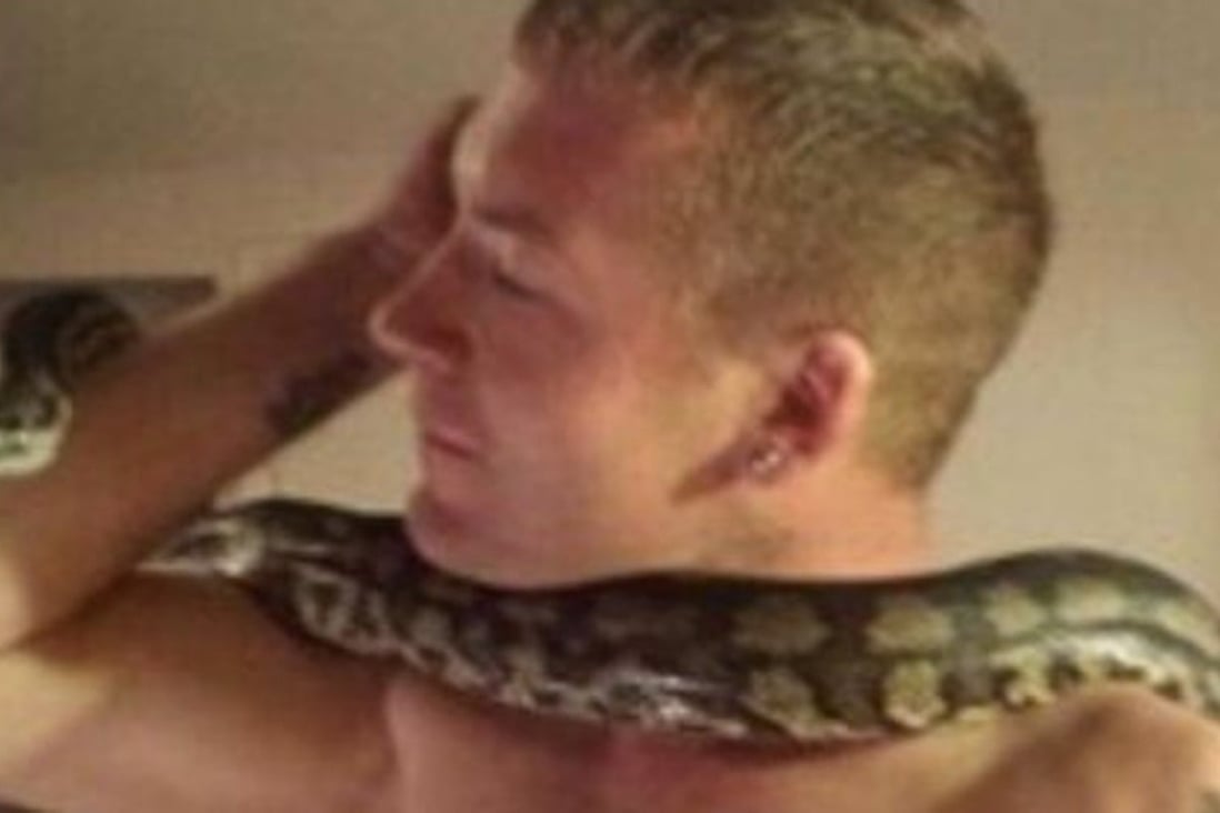 Dan Brandon (pictured with one of his many snakes) was killed by his pet python ‘Tiny’, a coroner ruled. Brandon, of Hampshire, England, had owned the snake since it was a baby. Photo: Facebook