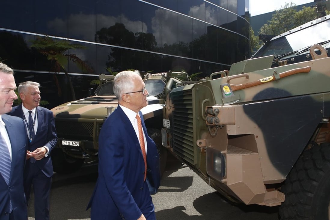 Australian Prime Minister Malcolm Turnbull inspects the Bushmaster military truck. Photo: EPA
