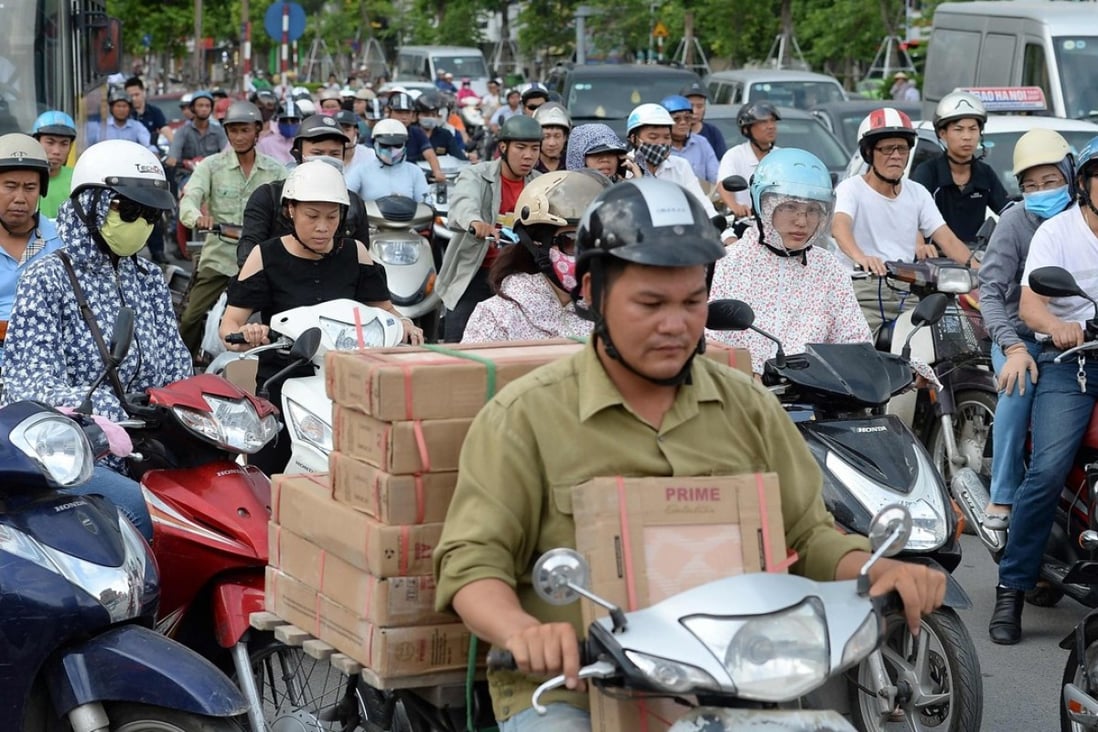 Motorcyclists cross an intersection in downtown Hanoi. Photo: AFP