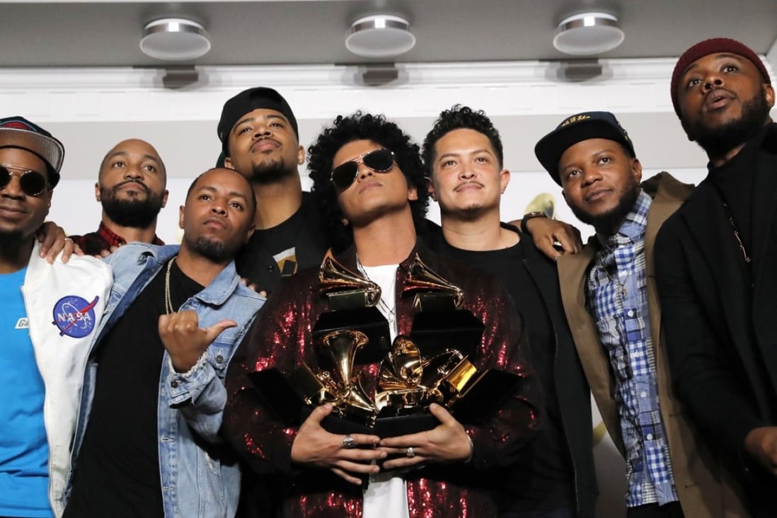 Bruno Mars holds six of his seven Grammys. Photo: Reuters/Andrew Kelly