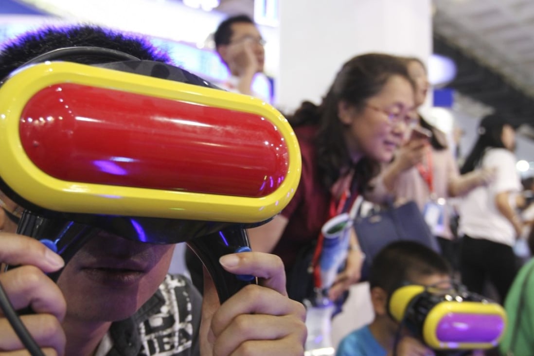 Visitors play VR video games at the 20th China Beijing International High-Tech Expo (CHITEC) opens in Beijing in June last year. Phioto: SCMP