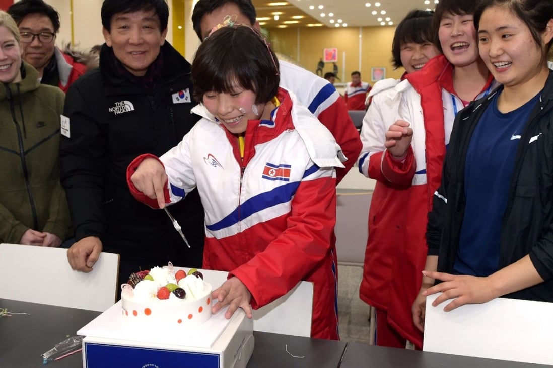 North Korean female ice hockey player Choe Un Gyong (C) cutting a cake while her North and South Korean teammates celebrate her birthday on January 29, 2018 at South Korea's national training center in Jincheon. Photo: Korean Sport and Olympic Committee via AFP