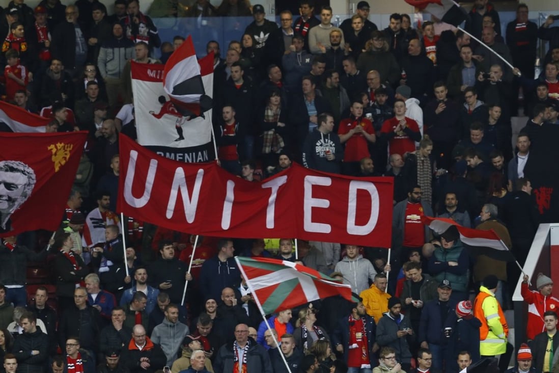 Manchester United fans wave flags ahead of their Uefa Europa League tie against Anderlecht at Old Trafford. Photo: Reuters