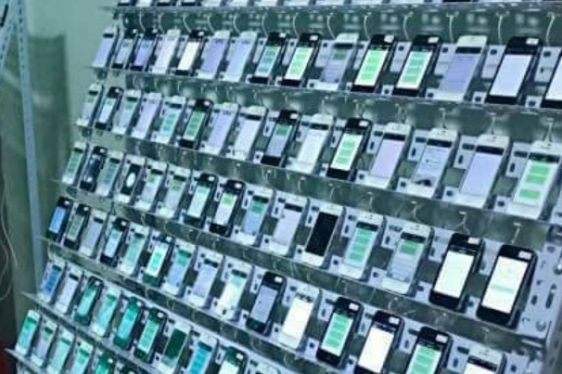 A click farm in Thailand, where scores of mobile phones are strung together to provide digital signatures that mimic the real responses of users. Photo: SCMP/Handout