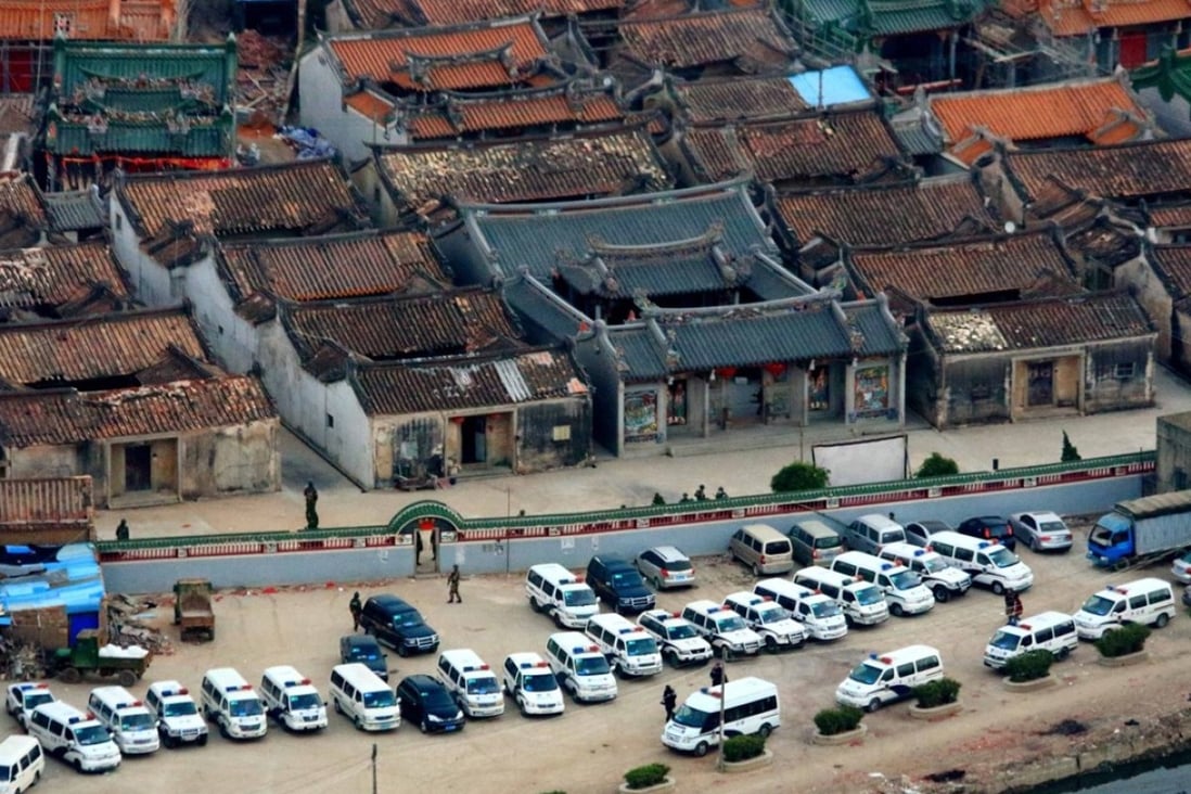Police cars park outside a village in Lufeng in south Guangdong province during a drug manufacturing bust in 2013. Photo: Xinhua