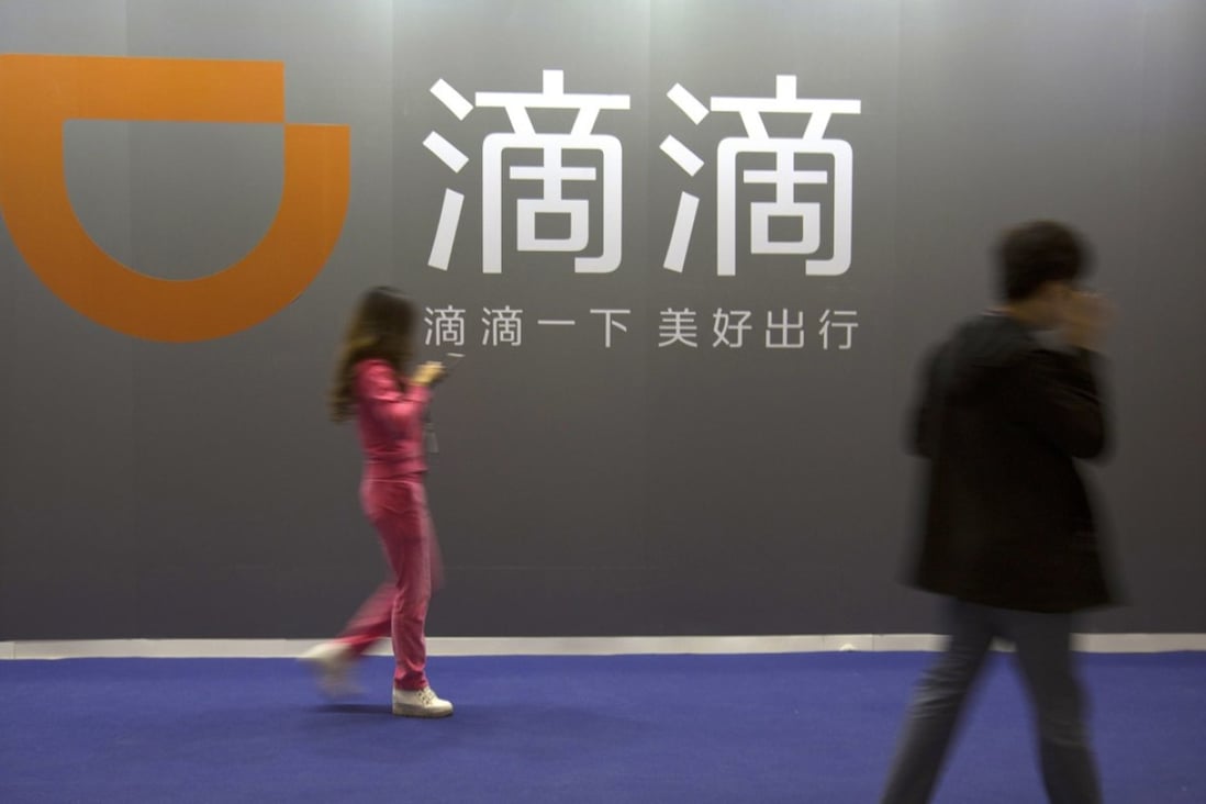 Didi Chuxing’s logo at an internet event in Beijing. The company is tying up with 12 carmakers in an alliance to enter China’s electric vehicle rental business. Photo: AP