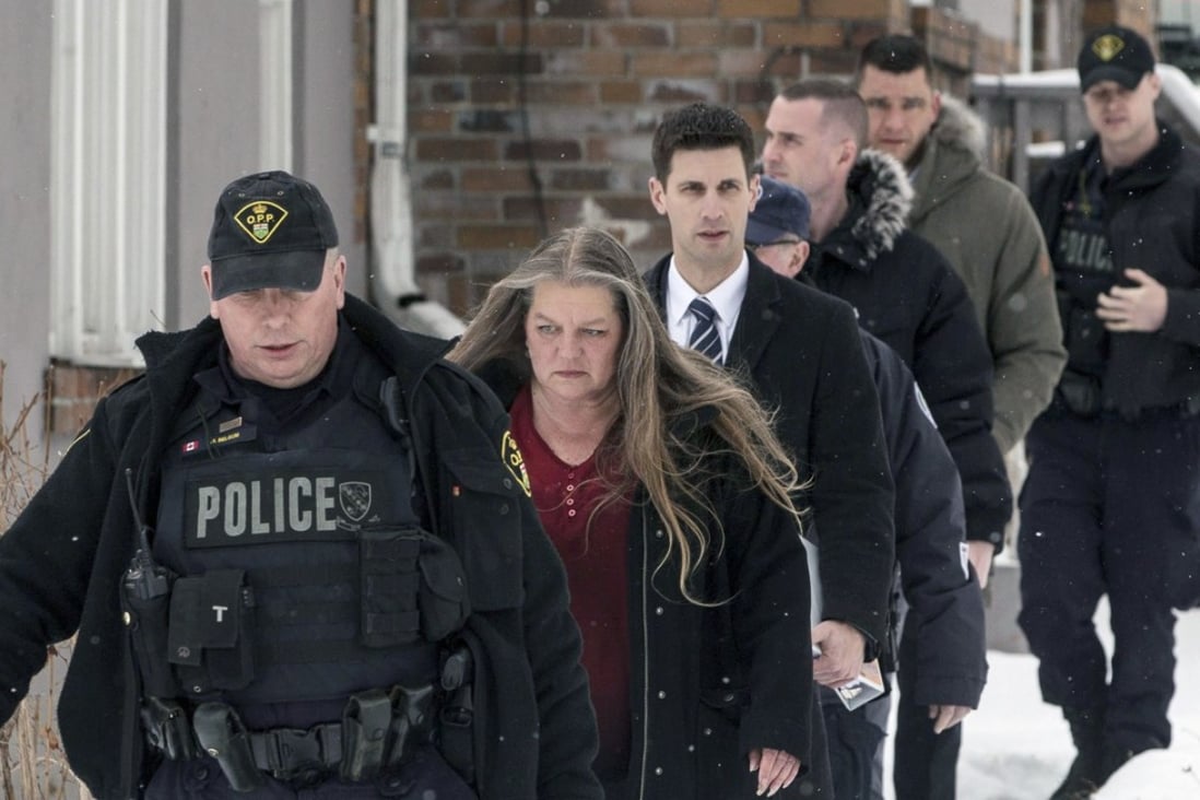 Forensic anthropologist professor Kathy Gruspier, second from left, walks with police officers on Thursday at a property where alleged serial killer Bruce McArthur worked in Toronto. Photo: AP