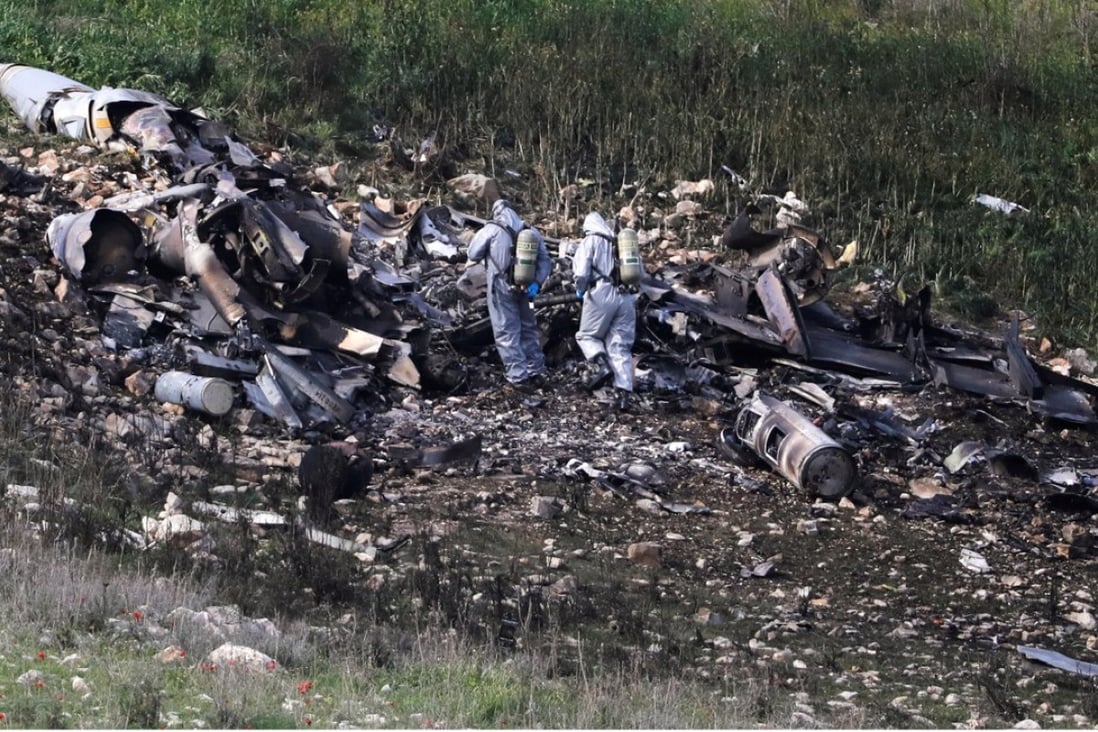 Security forces examine the remains of an Israeli F-16 war plane shot down near the Israeli village of Harduf. Photo: Reuters