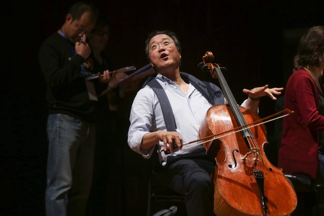 Yo-Yo Ma (centre), artistic director of YMCG (Youth Music Culture Guangdong), joking with students before a rehearsal at the Xinghai Concert Hall in Guangzhou, China. Photo: Xiaomei Chen