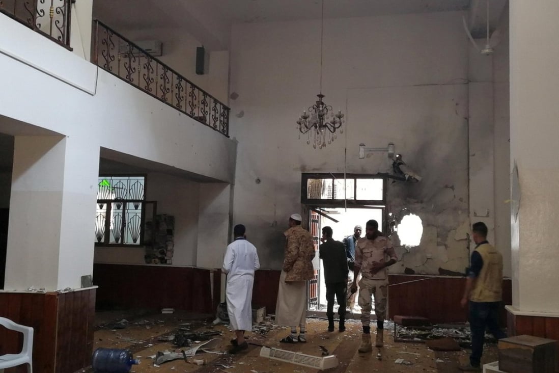 People inspect the damage inside a mosque following a twin bombing in Benghazi, Libya, on Friday. Photo: Reuters