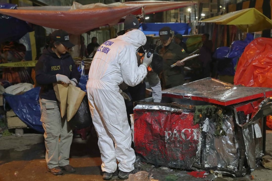 Police and forensics experts inspect the site of an explosion in Oruro, Bolivia, that killed eight on Saturday night. Photo: EPA